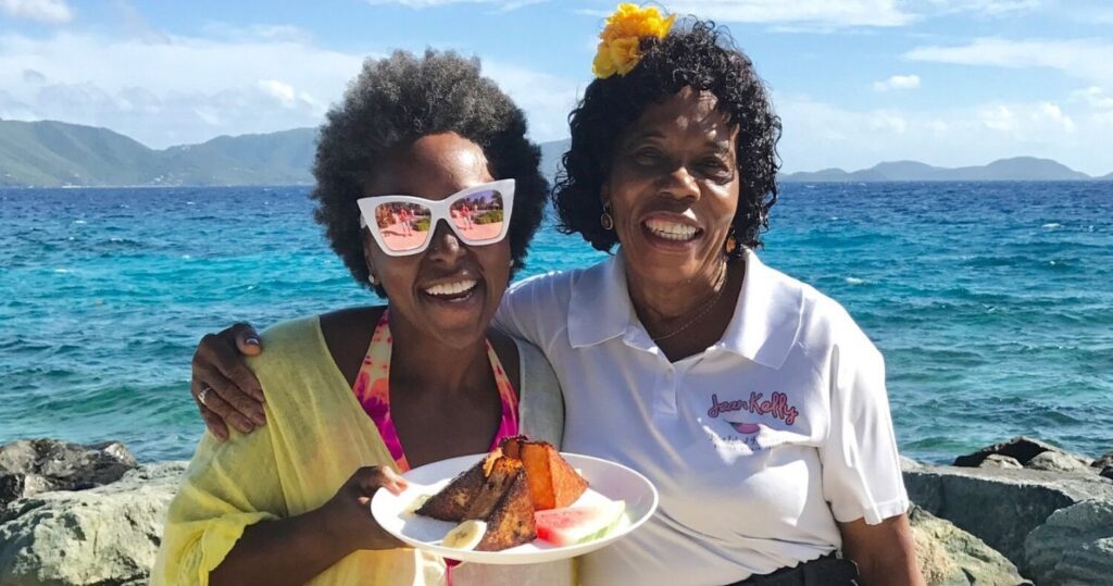 a tourist takes a photo with island resort staff