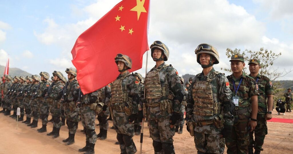 China's military personnel lined up with their flag